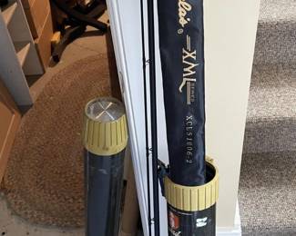 Assorted Fishing Rods with Storage Tubes and Protective Sleeves