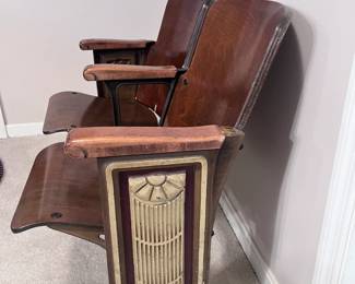 Wooden double-seat theater bench featuring ornate Art Deco metal end panels