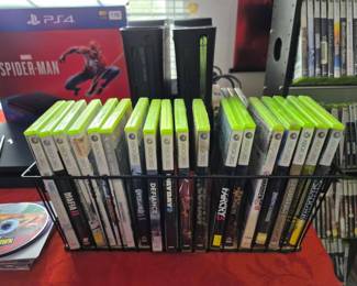 XBox 360 games and 2 consoles with cords.