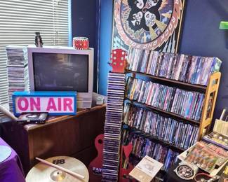 TV in picture is not for sale, it's there to test DVD's. The guitar CD stand is filled with 80's rock.