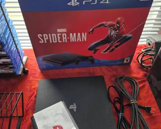 PlayStation 4 with cords and book. PS4