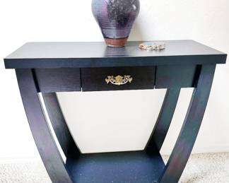 Black side table, pottery