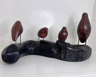 Decorative Wood Carving Featuring Four Small Birds Perched On A Curved Branch