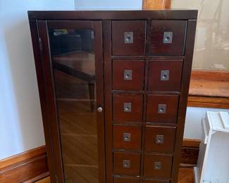dark wood storage cabinet with drawers and a glass door, perfect size for CDs and DVDs