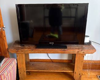 Samsung flat screen TV and a very lovely rustic bench