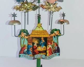 antique German lithographed tin Christmas angel chime, commonly known as an Engelsgeläute, featuring a Nativity scene and a "Friede auf Erden" ( Peace on earth) banner.