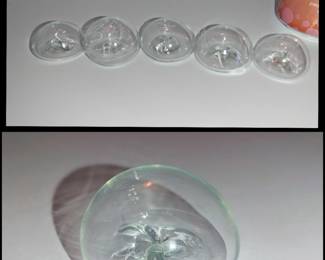 Hand flown hollow glass orbs. This design enhances the way ambient light refracts through the outer glass dome and plays across the internal sculpted centerpiece. Rough pontil on the bottom. Of course they all look different and several look like the figure of an angel or a butterfly when you hold them to the light