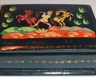 Vintage Russian Palekh hand-painted black lacquer trinket box featuring a traditional folk art scene with horses and figures. Artist signed