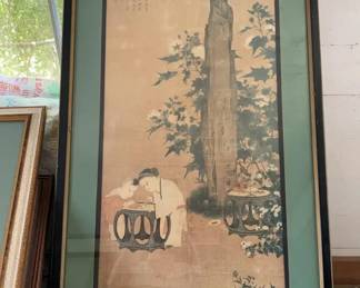 Children at Play in an Autumnal Garden Print 1950-80 This framed art piece is a reproduction print of a classical Chinese painting depicting two children playing in a garden next to ornamental rocks and flowers, presented in a black frame with a wide green mat.