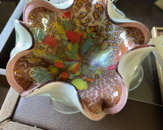 Murano Tutti Frutti Art Glass Bowl 1050-1960 This hand-blown Italian art glass bowl features a ruffled, handkerchief-style rim and an intricate multicolored murrine and aventurine pattern encased in clear glass. The interior displays vibrant splashes of red, yellow, and green surrounded by dense mosaic glass cane slices.