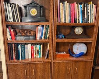 Book collection & antique clocks . Glass art