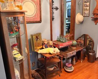 Antique decor, display cabinet, Hess trucks, vintage baby dolls, stoneware, military helmet & wooden desk 