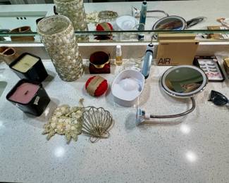 candles, shell decor, makeup mirror, toothbrush holder, electric toothbrush