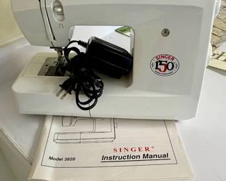 Singer sewing machine with foot and manual
