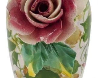 275 - Vintage Italian Porcelain Vase w/ Rose 7" (Description): Vintage Italian porcelain vase featuring a  sculptural applied rose bloom in pink and  cream tones. The baluster-form body is  hand-painted with trailing ivy, leaves, and  floral sprigs in green, yellow, and pink against a cream ground. The dimensional rose  adds an elegant dimensional accent to this  decorative piece. Measures 7 inches tall.