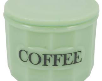 154 - Jadeite Coffee Container w/ Lid 4.5"x4.5" (Description): Jadeite glass coffee container with matching  lid. This charming kitchen canister features  the word "COFFEE" printed in black lettering  on the front, with a paneled design around  the body. The soft green jadeite color is characteristic of mid-century kitchenware.  Measures 4.5 inches in height by 4.5 inches  in diameter.