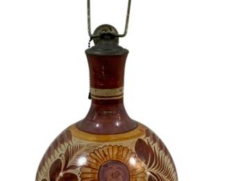 2348 - Mexican Folk Art Pottery Lamp AS/Damaged 25" (Description): Mexican folk art pottery lamp featuring  traditional hand-painted floral and leaf  designs in earthy tones of brown, cream, and  gold. The lamp has a globular body with  horizontal banding and sits on a turned wooden base. Sold as-is with noted damage.  Measures 25 inches tall Used as is electric/electronic/mechanical  item. No guarantee all components, untested.  .