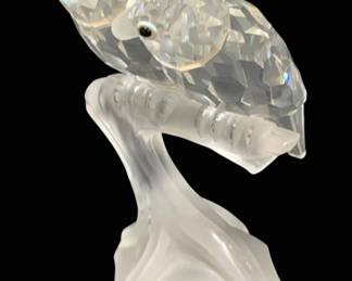 2299 - Swarovski Parrots 4" (Description): Swarovski crystal parrots figurine featuring  two birds perched together on a frosted  crystal branch and base. Measures 4 inches in  height.