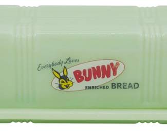 146 - Jadeite Glass Butter Dish 2.5"x6.5"x3" (Description): Jadeite glass butter dish featuring the  classic "Everybody Loves Bunny Enriched  Bread" advertising logo on the lid. The dish  has a ribbed rectangular design with a  matching base and domed lid. Measures 2 1/2" x 6 1/2" x 3".