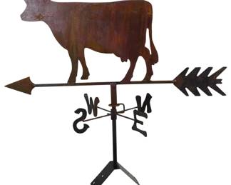 197 - Rustic Metal Cow Weathervane 25" (Description): Rustic metal cow weathervane featuring a flat  silhouette cow figure mounted atop an arrow  directional with N, S, E, W cardinal markers.  The piece displays a weathered patina finish  in warm rust tones, giving it an aged farmhouse appearance. Includes mounting  bracket at base. Measures 25 inches.