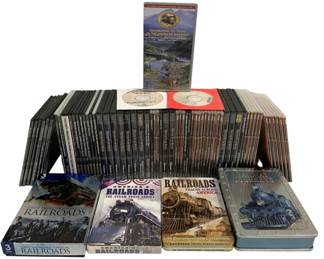 1064 - 65pc Railroad Documentary DVD & VHS Group (Description): A collection of railroad documentary DVDs and  VHS tapes featuring various titles including  Great American & European Railroads,  America's Railroads: The Steam Train Legacy,  Railroads Tracks Across America 36 Documentary Collection, Railway Journeys,and  Celebrating 175 Years of the American  Railroad. The collection includes multiple  boxed sets in decorative tin cases as well as  individual disc cases, offering