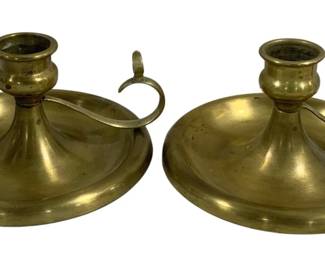 2074 - Pair Brass Finger Candleholders 8.5"x5" (Description): Two-piece brass candleholders featuring a  traditional chamber stick design with finger  loop handles. Each candleholder measures 8  1/2 inches by 5 inches.
