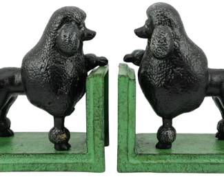 95 - Pr Cast Iron Poodle Bookends 6.5" (Description): Pair of cast iron poodle bookends featuring  black standard poodles in classic show cut  standing on stepped green painted bases. The  poodles are positioned with their front paws  resting on the upright book support. Each bookend measures 6.5 inches.