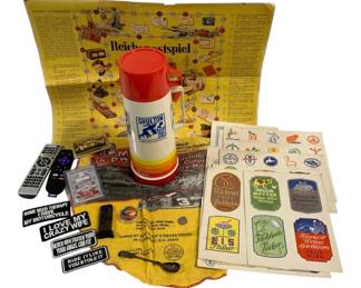 1558 - Collectibles Lot with Thermos & Ephemera (Description): An eclectic lot of vintage collectibles  including a Shulton branded thermos with red  lid and rainbow striped base, a German  Reichspostspiel board game sheet, assorted  German advertising labels and stickers featuring bakeries and shops, a Dale  Earnhardt Winston Cup Championship signed bag  from M&M Pop's Smoke House in Cullowhee NC,  vintage cassette tapes, a remote control,  assorted motorcycle-themed novelty patches