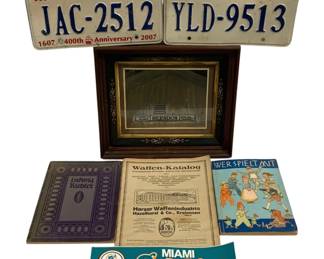 1556 - Virginia License Plates, German Books & More (Description): An assorted lot of collectibles including two  Virginia license plates (one commemorating  the 400th Anniversary 1607-2007), a framed  photograph or print of the Herndon building,  a Ludwig Richter book with dark blue cover, a vintage German Waffen-Katalog (weapons  catalog) from Harzer Waffenindustrie  Haselhorst & Co. Kreiensen, a German  children's book titled 'Wer Spielt Mit'  featuring colorful illustrated cover, and a