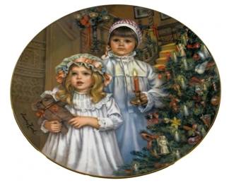 2097 - Sandra Kuck Collector Plate 9.25" (Description): Sandra Kuck collector plate featuring a  Christmas scene with children. The plate  measures 9.25 inches in diameter and features  the artist's signature on the front.