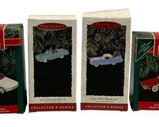 2318 - 4 Hallmark Car Ornaments (Description): A lot of four Hallmark car ornaments. These  collectible Keepsake ornaments feature  classic American cars and come in their  original boxes.