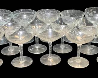 2301 - 12 Champagne Glasses (Description): A lot of 12 glasses. These clear glass pieces  feature elegant stems and rounded bowls,  suitable for various beverage service.