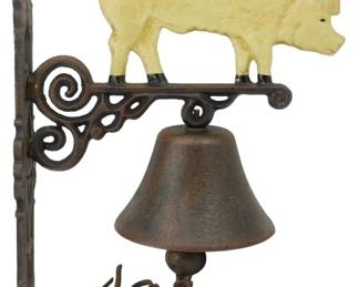 121 - Cast Iron Wall Pig Bell 13"x11" (Description): Cast iron wall-mounted bell featuring a  painted pig figure atop a decorative  scrollwork bracket. The pig is finished in  cream or pale yellow paint with black hooves,  while the bracket and bell display a rustic brown patina. Measures 13 inches by 11  inches.