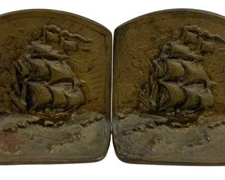 2075 - Pair Metal Ship Bookends 4.75"x5"x2" (Description): A two-piece set of metal bookends featuring  relief sailing ship designs. Each bookend  measures 4 3/4 inches by 5 inches by 2  inches.