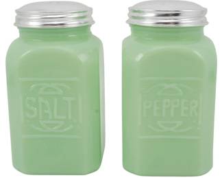 148 - Jadeite Salt and Pepper Shakers 5" (Description): Pair of jadeite glass salt and pepper shakers  featuring embossed "SALT" and "PEPPER"  lettering on the front panels. The shakers  have a classic square shape with rounded  corners and are topped with screw-on lids. Each shaker measures 5 ins tall.