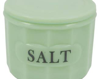 155 - Jadeite Salt Container w/ Lid 4.5"x4.5" (Description): Jadeite glass salt container with matching  lid. The cylindrical container features a  paneled design with "SALT" lettered on the  front in dark text. The pale green jadeite  glass has the characteristic opaque, milky appearance typical of this collectible  glassware style. Measures 4.5" x 4.5".