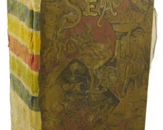 32 - 1887 Assumed 1st Ed. Sea & Land Book (Description): An 1887 assumed first edition of Sea & Land.  This antique volume features an ornate  pictorial cover with decorative imagery  including tropical scenes, figures, and fauna  in muted olive and red tones. The title page is missing and the spine has been replaced  with striped fabric binding in yellow, blue,  and red. The book shows age-related wear  consistent with its late 19th century origin.
