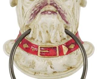 101 - Cast Iron Bulldog Knocker 8"x5"x3.5" (Description): Cast iron bulldog door knocker featuring a  detailed bulldog head with a painted red  collar adorned with gold-tone studs and  buckle. The knocker ring hangs from the  collar. Measures 8" x 5" x 3.5".
