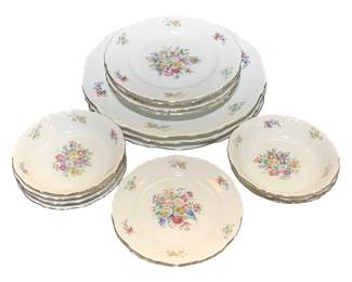 2353 - 16 Crown Bavaria China Set (Description): A 16-piece set of Crown Bavaria china  featuring a delicate floral pattern. The set  includes various plates and bowls, each  decorated with central floral bouquets and  scattered flower sprigs on a white ground with scalloped edges.