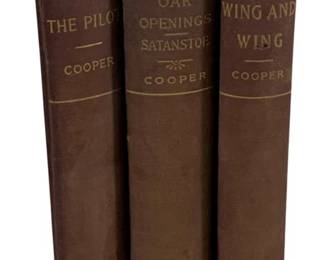 2357 - 3 J. Fenimore Cooper Books (Description): A three-piece set of books by J. Fenimore  Cooper. The collection includes 'The Pilot,'  'Oak Openings / Satanstoe,' and 'Wing and  Wing.' All three volumes are bound in  matching brown cloth covers with gilt lettering on the spines, appearing to be from  the Oxford Edition series.