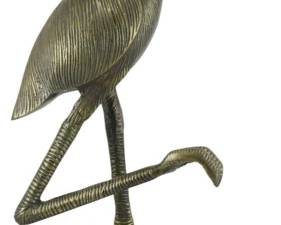 130 - Metal Flamingo Figure Stand 24" (Description): Decorative metal flamingo figure with an  antiqued brass finish. The stylized bird  stands on one leg atop a circular base with  textured detailing, with its other leg raised  in a characteristic flamingo pose. The figure features an etched feather pattern  throughout the body and wings, with a shallow  dish or tray incorporated into the bird's  back. Measures 24 inches tall.