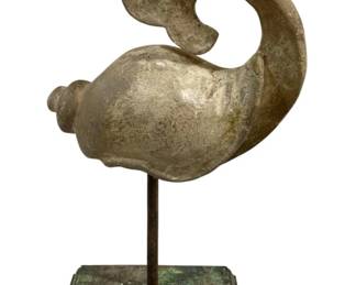 2455 - Seashell Decoration 12"x8"x5" (Description): Decorative seashell sculpture mounted on a  stand. The piece features a stylized shell  form with a curling tail, presented on a  pedestal base. Measures 12 inches by 8 inches  by 5 inches.