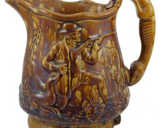 603 - Bennington Pottery Pitcher Vase Chipped 10" (Description): Bennington Pottery pitcher vase featuring  relief decoration. The piece has a chip at  the bottom. Measures 10 inches in height.