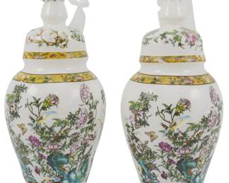 248 - Pr Blown Glass Chinoiserie Jar Ornaments (Description): A pair of Danny's Fine Porcelain Rose Canton  ginger jar ornaments. These decorative glass  ornaments are shaped like traditional Chinese  covered ginger jars with domed lids topped  by frosted white elephant finials. The jars feature a white ground with colorful  hand-painted style floral decoration  including pink peonies, green foliage, birds,  and butterflies, accented by yellow  decorative bands. Each ornament measures 5.5