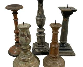 2441 - 5 Candle Prickets 9" - 13.5" Tall (Description): A collection of five candleholders in various  turned wood designs. The pieces display  weathered painted finishes in muted tones,  with visible patina and age-appropriate wear  throughout. Each candleholder features a pricket-style spike for securing candles.  Heights range from 9 inches to 13.5 inches  tall.