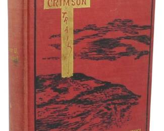 23 - 1912 First Edition The Crimson Trail (Description): First edition of The Crimson Trail by Elmer  U. Hoenshel, published in 1912. The book  features a striking red cloth binding with  decorative gilt and black pictorial cover  design depicting a cross and crown motif with radiating sunbeams. The spine displays the  title and author's name in gilt lettering. A  handsome example of early 20th century  Christian devotional literature with  period-appropriate decorative binding.
