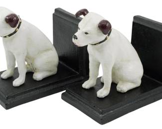 91 - Pr Cast Iron RCA Nipper Dog Bookends (Description): A pair of cast iron bookends featuring the  iconic RCA Nipper dog. Each bookend depicts a  seated white terrier with a distinctive  brown ear patch and studded collar, mounted  on a black painted L-shaped cast iron base. The dogs are painted in white with brown  accents and black detailing on the nose and  eyes. These charming bookends capture the  likeness of the famous 'His Master's Voice'  mascot in a classic seated pose.
