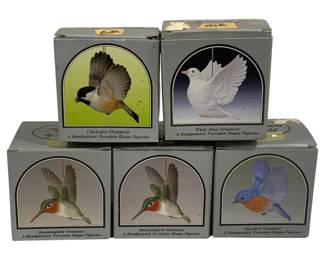 2080 - 5 Andrea Bird Ornaments in Boxes (Description): A collection of five Andrea bird ornaments,  each in its original box. The lot includes  handpainted porcelain bisque figurine  ornaments featuring various bird species  including a chickadee, white dove, two hummingbirds, and a bluebird.