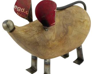 88 - Abstract Mouse Figure 7" (Description): Abstract mouse figure measuring 7 inches.  This whimsical folk art piece features a  carved wooden body with metal legs and tail.  The ears are crafted from repurposed red  painted metal with visible text, and a metal ball serves as the nose. The piece combines  rustic wood with industrial metal elements  for a charming, sculptural effect.
