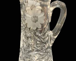 2304 - Crystal Pitcher 11.5" (Description): Crystal pitcher featuring cut glass design  with floral motif. Measures 11.5 inches in  height.